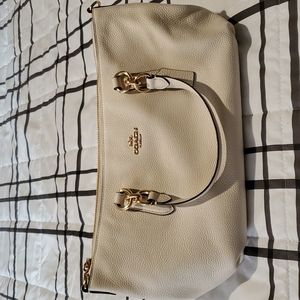Coach purse cream color with gold accent.